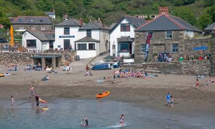 a sunny day outside the Rashleigh inn at the beach at Polkerris near Fowey